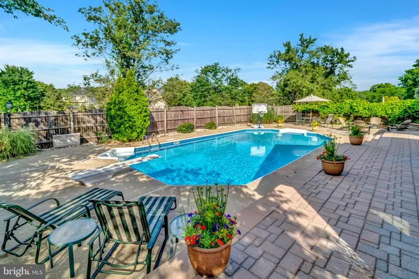 a view of a patio with couches table and chairs and potted plants
