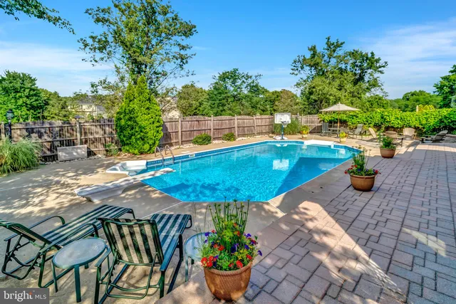 a view of a patio with couches table and chairs and potted plants