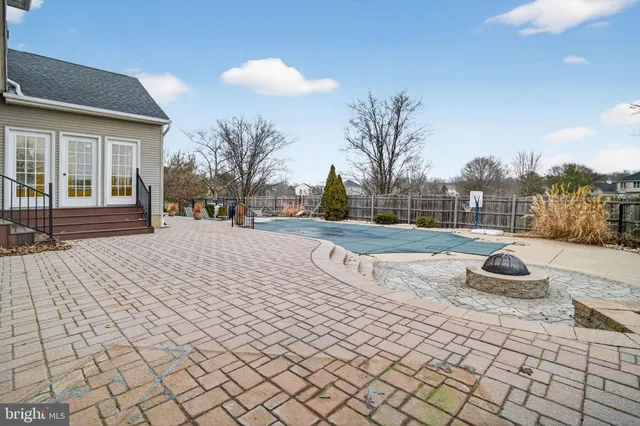 an aerial view of a house with swimming pool garden and patio