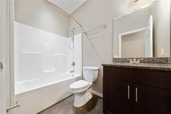 a bathroom with a granite countertop sink two mirror and a
