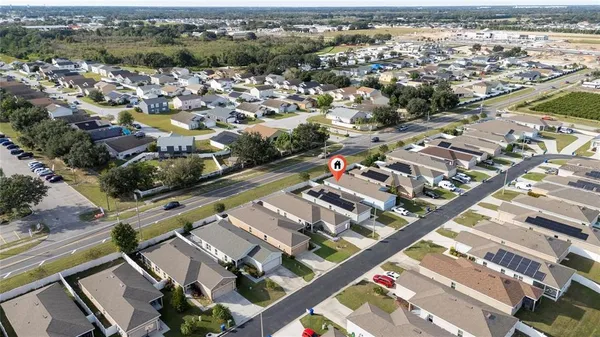 an aerial view of a house with a yard