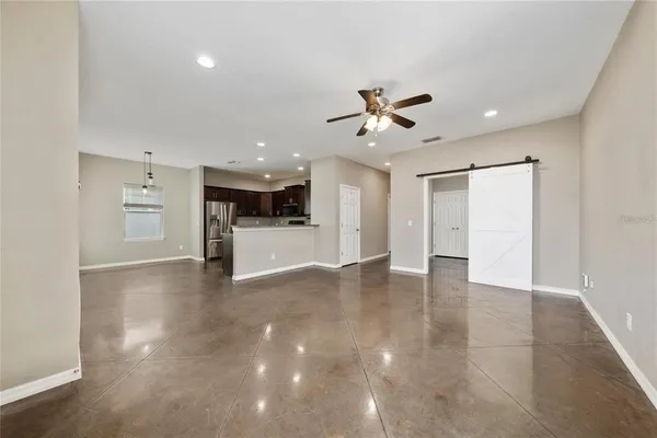 a view of a kitchen with a sink and a refrigerator