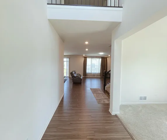 a view of a living room with wooden floor