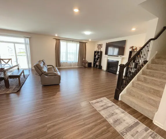a living room with furniture and a hard wood floor