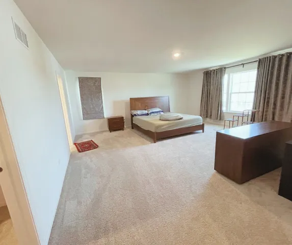 a bedroom with a bed and a couch