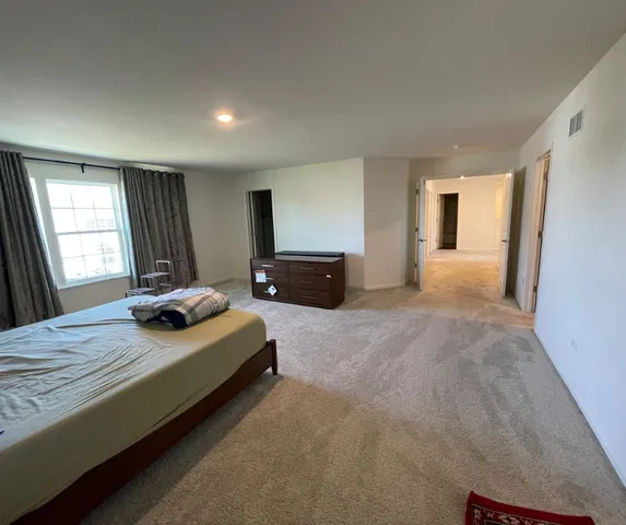 a bedroom with bed and window