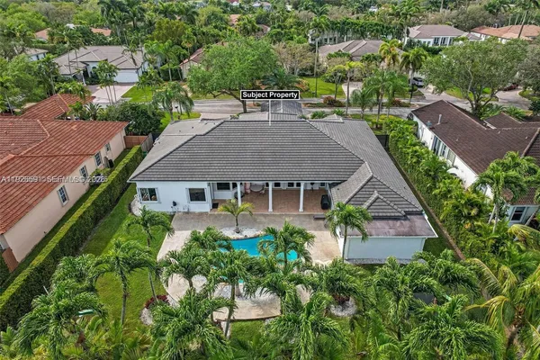 an aerial view of a house with garden space and street view