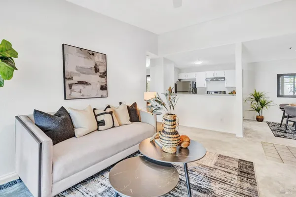 a living room with furniture a rug and a large window