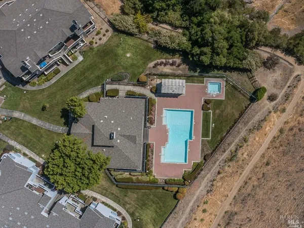 an aerial view of a house with a yard
