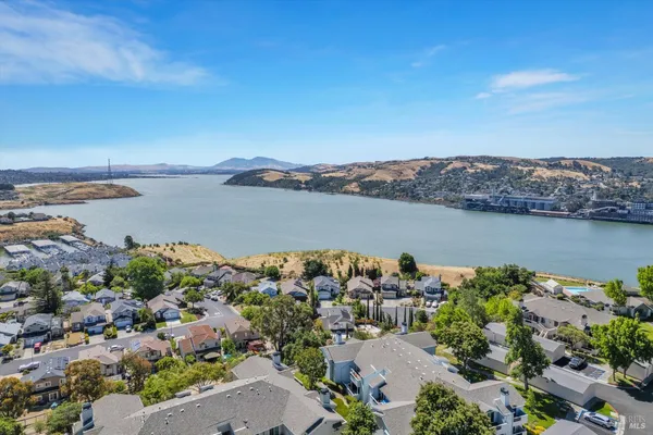 an aerial view of a houses with a lake view