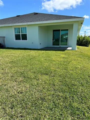 a living room with lots of furniture and kitchen view