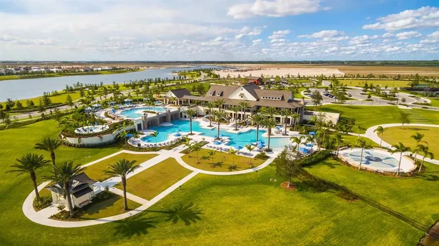a view of a swimming pool with a patio and a yard