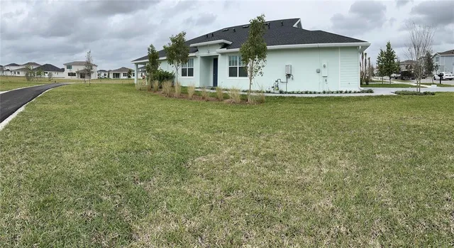a front view of a house with a garden and yard