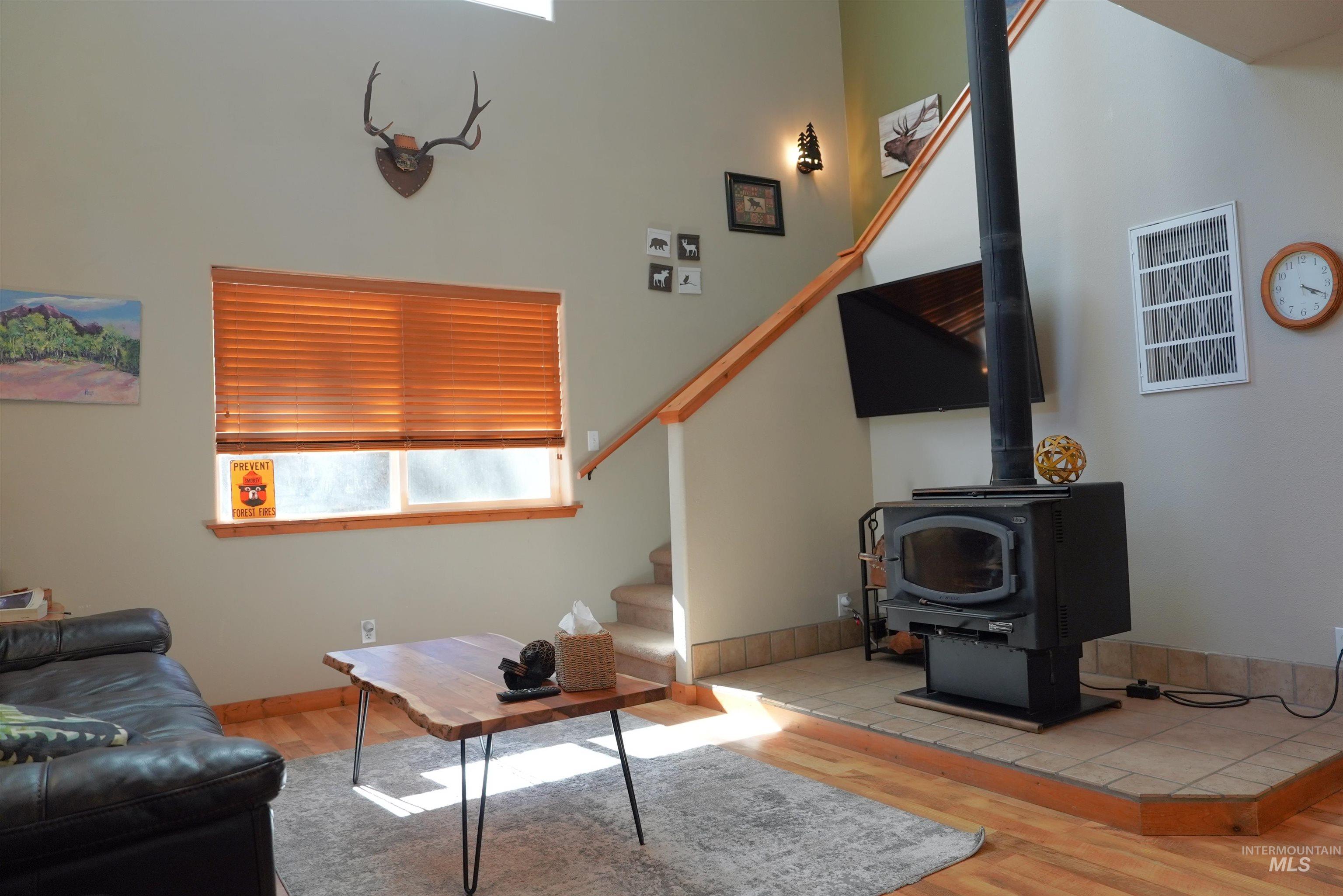 14 Forest Trail Road Garden Valley, ID 83622 - Photo 19 of 45 Living room featuring light wood-style flooring, plenty of natural light, and a wood stove