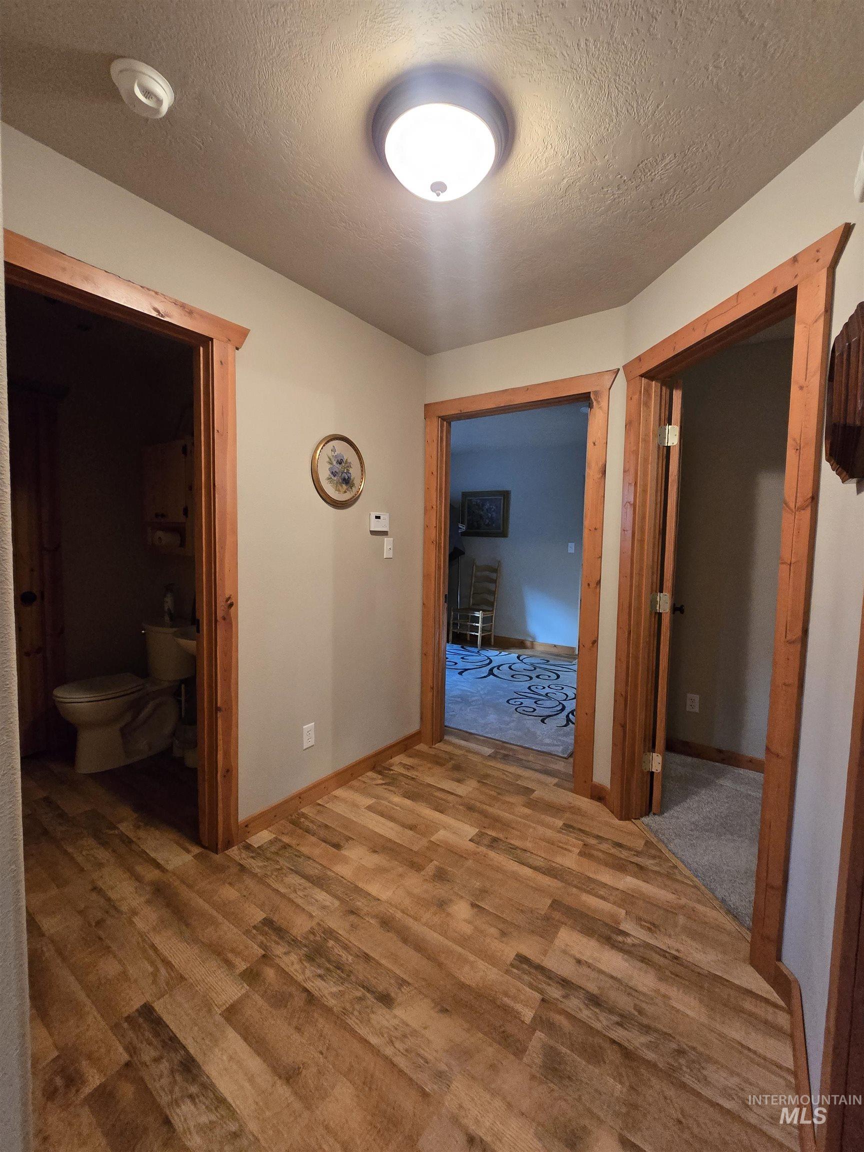 14 Forest Trail Road Garden Valley, ID 83622 - Photo 22 of 45 Corridor with a textured ceiling and light wood-type flooring