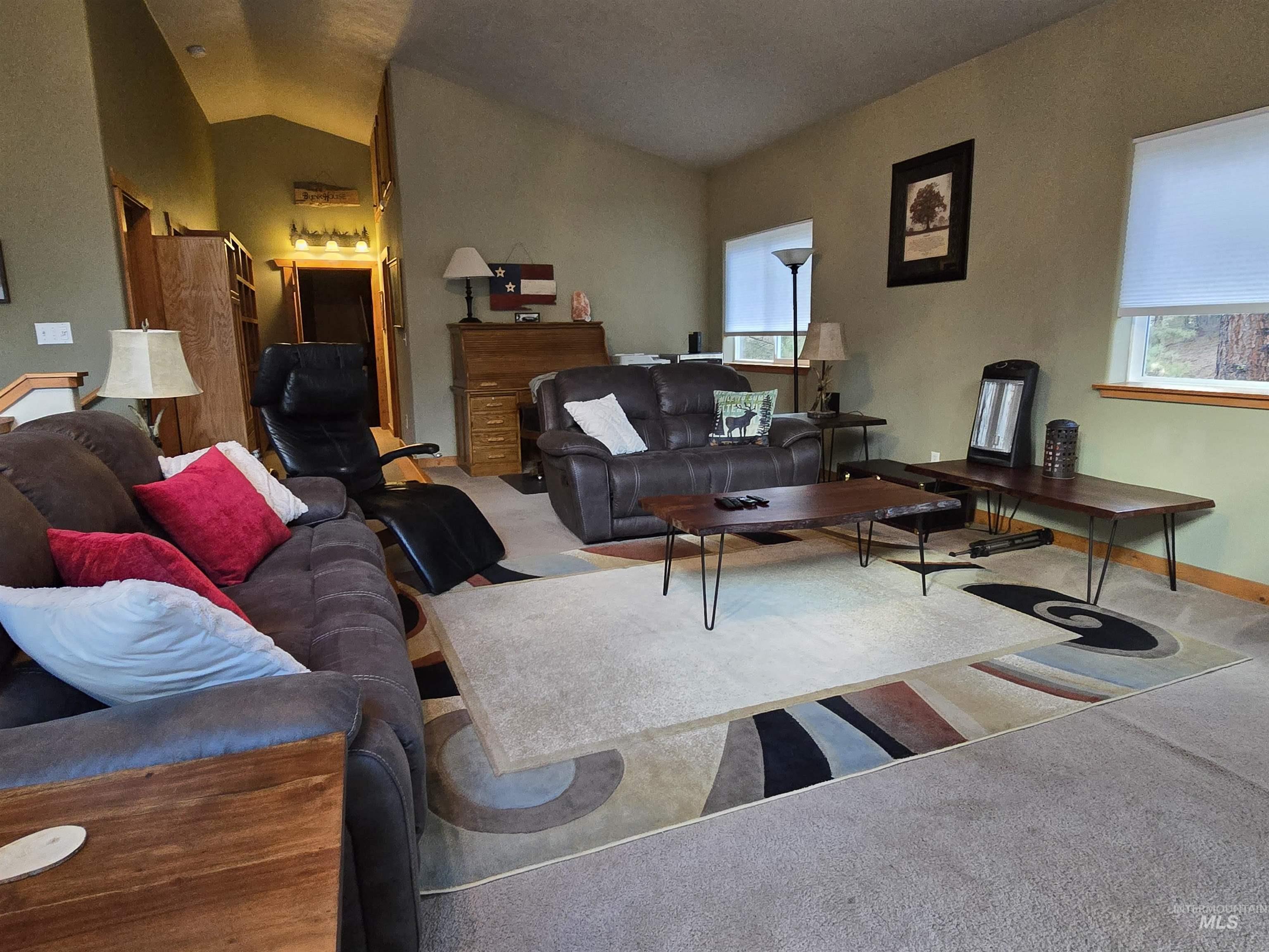 14 Forest Trail Road Garden Valley, ID 83622 - Photo 29 of 45 Carpeted living area featuring vaulted ceiling and plenty of natural light
