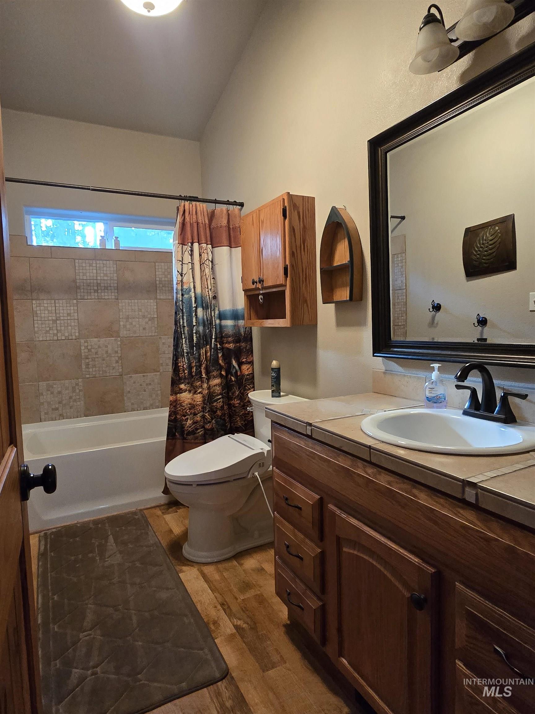 14 Forest Trail Road Garden Valley, ID 83622 - Photo 30 of 45 Bathroom with vanity, dark wood finished floors, and shower / bathtub combination with curtain