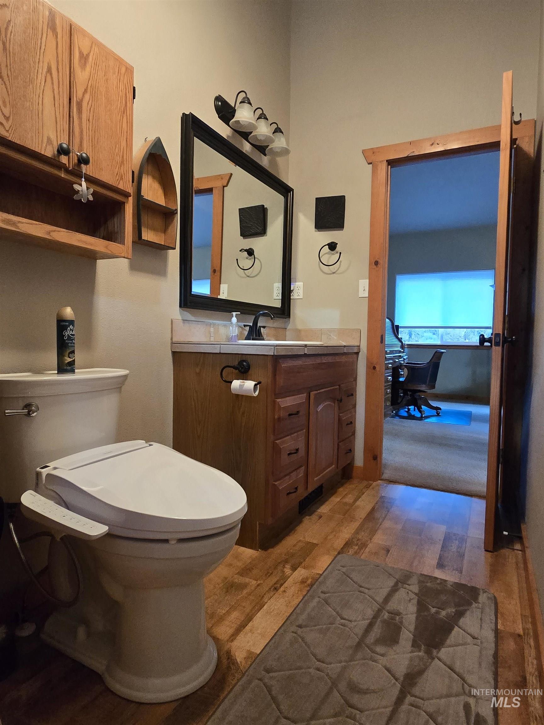14 Forest Trail Road Garden Valley, ID 83622 - Photo 31 of 45 Half bathroom with vanity and dark wood finished floors
