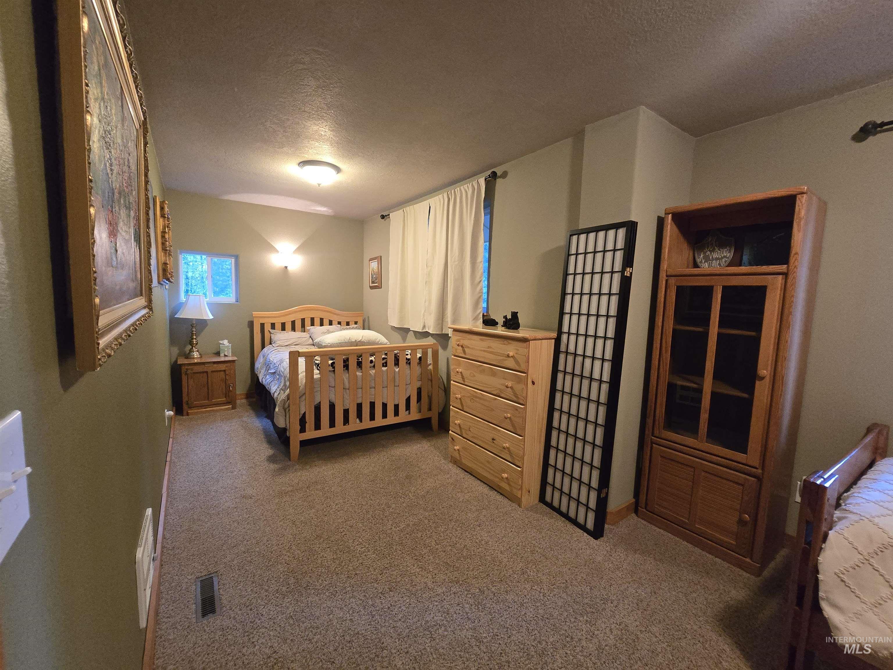 14 Forest Trail Road Garden Valley, ID 83622 - Photo 36 of 45 Bedroom with a textured ceiling and light colored carpet