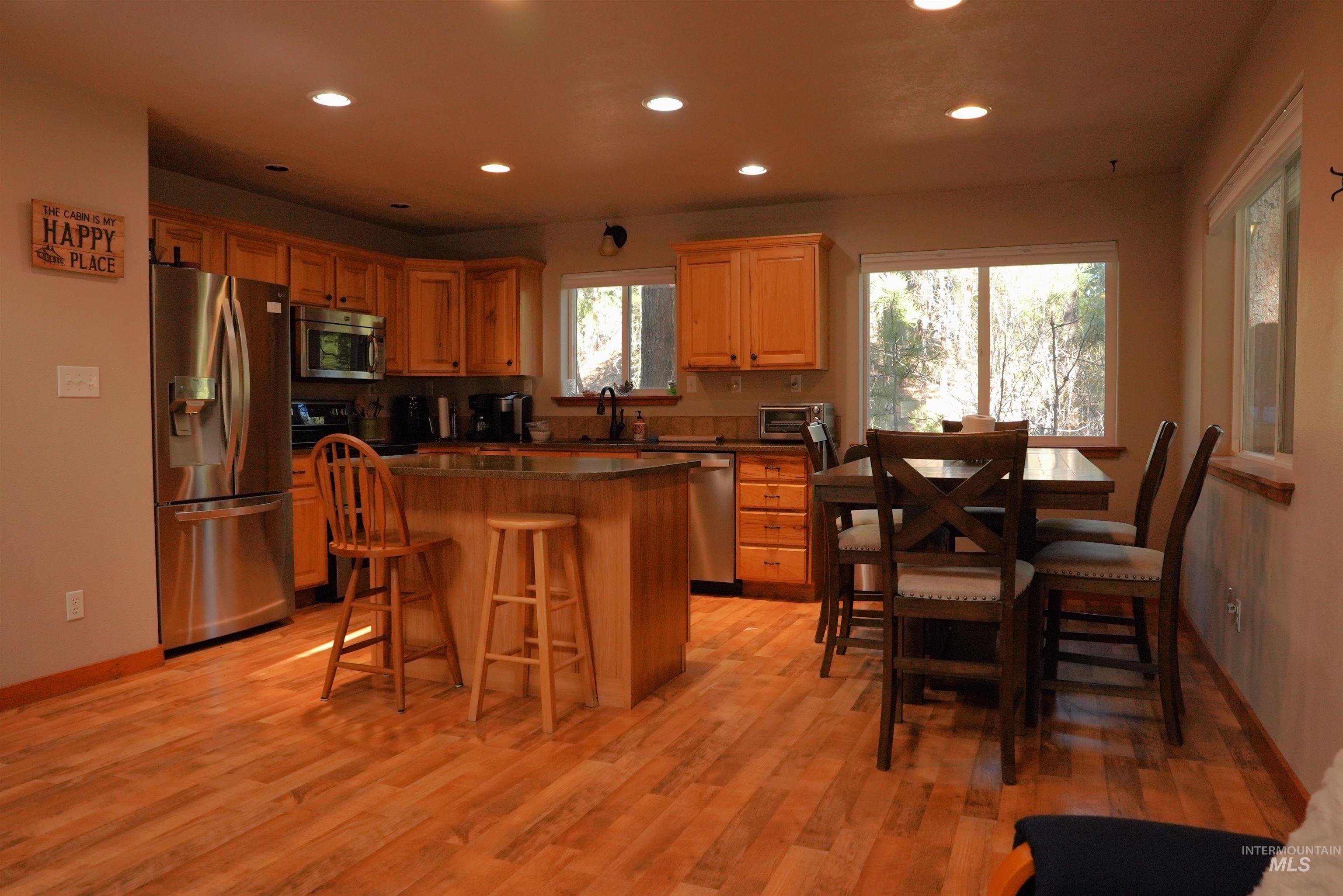 14 Forest Trail Road Garden Valley, ID 83622 - Photo 10 of 45 Kitchen featuring stainless steel appliances, a breakfast bar, recessed lighting, a center island, and light wood finished floors