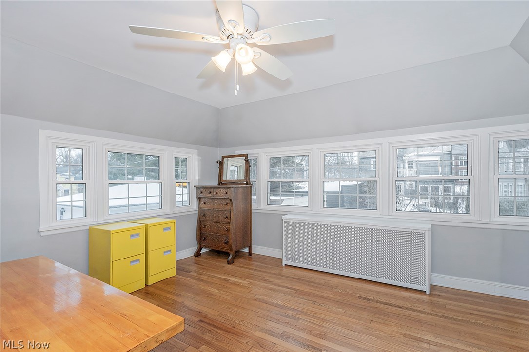 3259 Avalon Road Cleveland, OH 44120 - Photo 23 of 31 Unfurnished office featuring radiator, ceiling fan, light wood finished floors, and vaulted ceiling