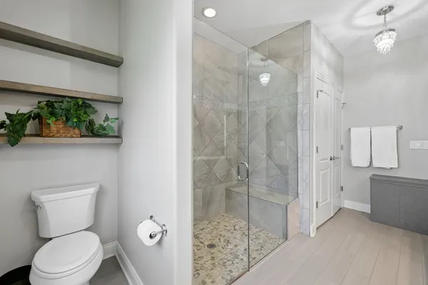 a bathroom with a toilet a sink and shower