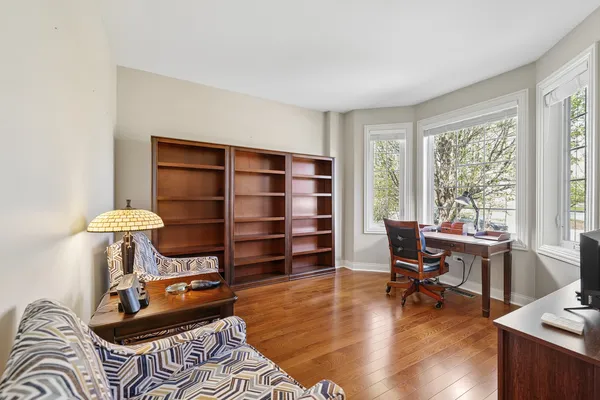 a living room with furniture a piano and a window