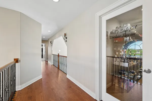 a view of a hallway with wooden floor and dining room