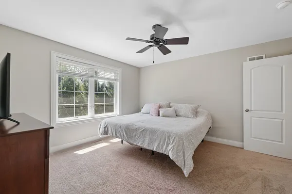 a living room with furniture a rug and a chandelier