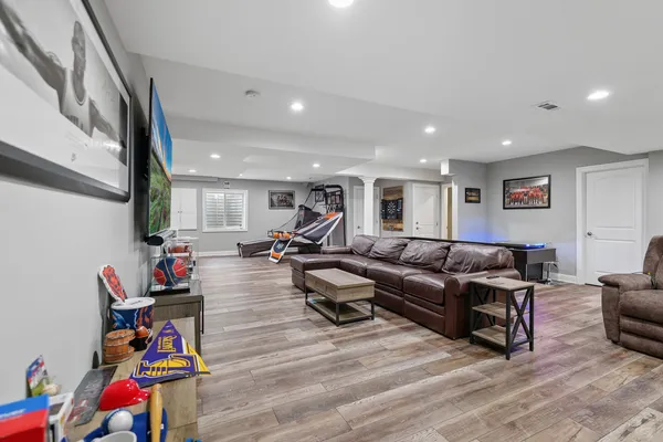 a view of a hallway with furniture and wooden floor