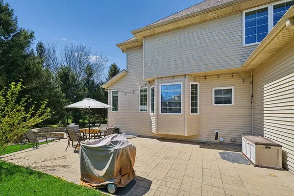 a view of a house with backyard sitting area and swimming pool