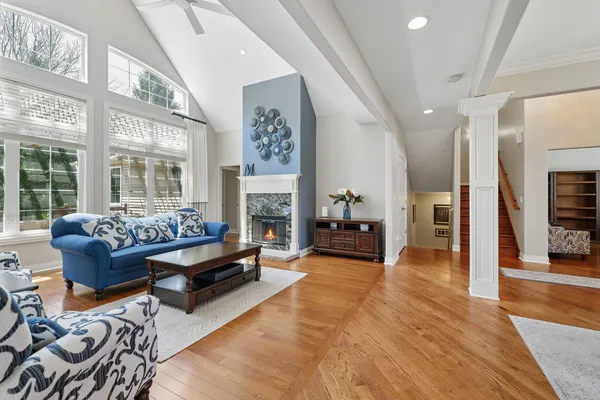 a living room with fireplace furniture and a floor to ceiling window