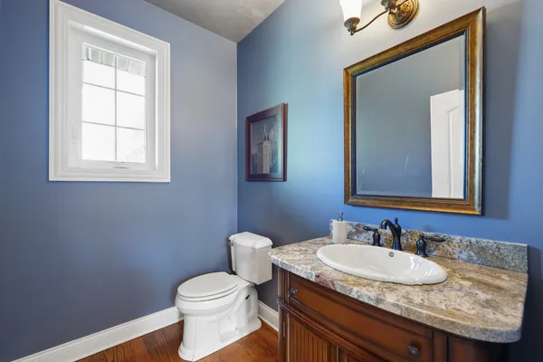 a bathroom with a granite countertop sink vanity and a mirror
