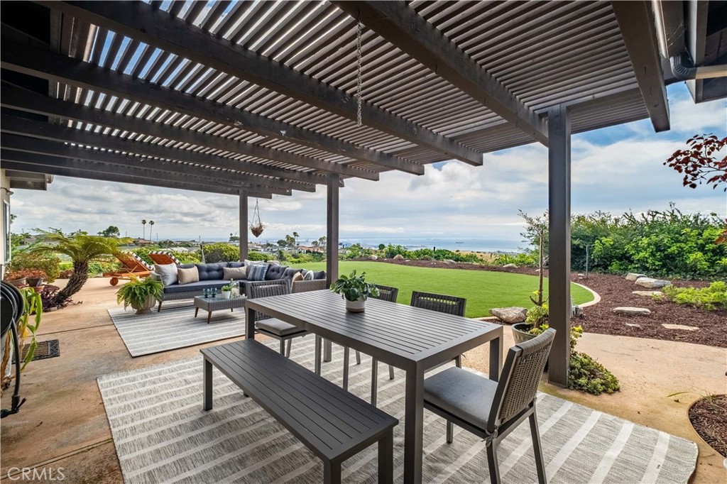 2727 San Ramon Drive Rancho Palos Verdes, CA 90275 - Photo 21 of 58 a view of a patio with couches and table under an umbrella