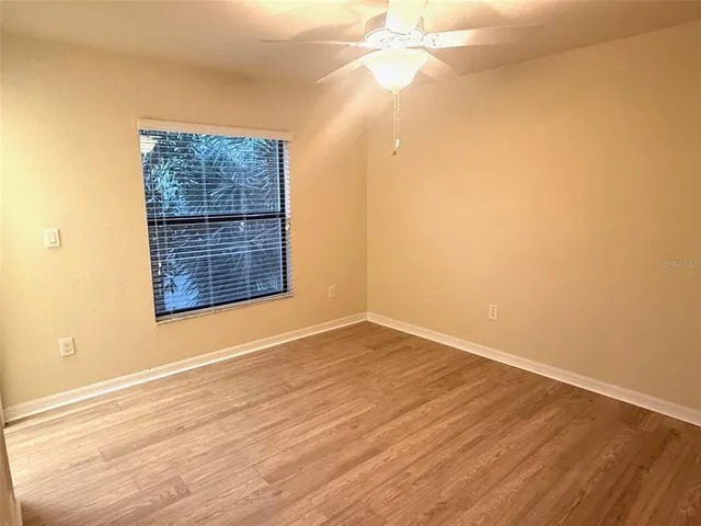 a bathroom with a granite countertop bathtub shower sink vanity and toilet