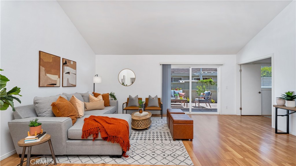 56 Wetstone, Unit 35 Irvine, CA 92604 - Photo 1 of 36 a living room with furniture and wooden floor