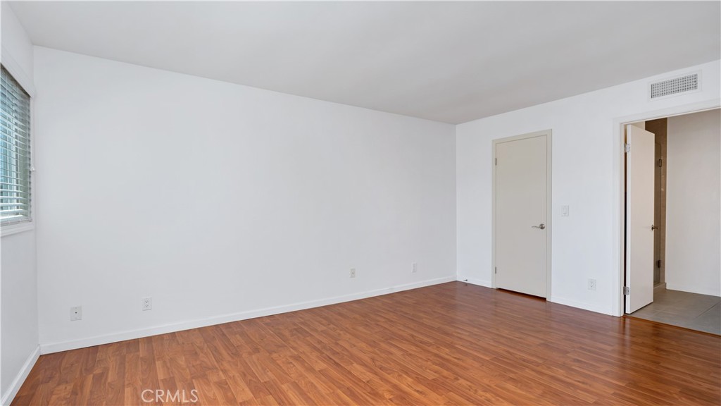 56 Wetstone, Unit 35 Irvine, CA 92604 - Photo 14 of 36 a view of empty room with wooden floor