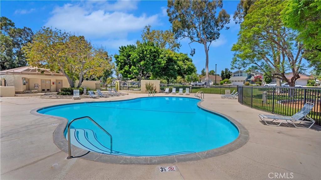 56 Wetstone, Unit 35 Irvine, CA 92604 - Photo 20 of 36 a view of a swimming pool with a patio and a yard