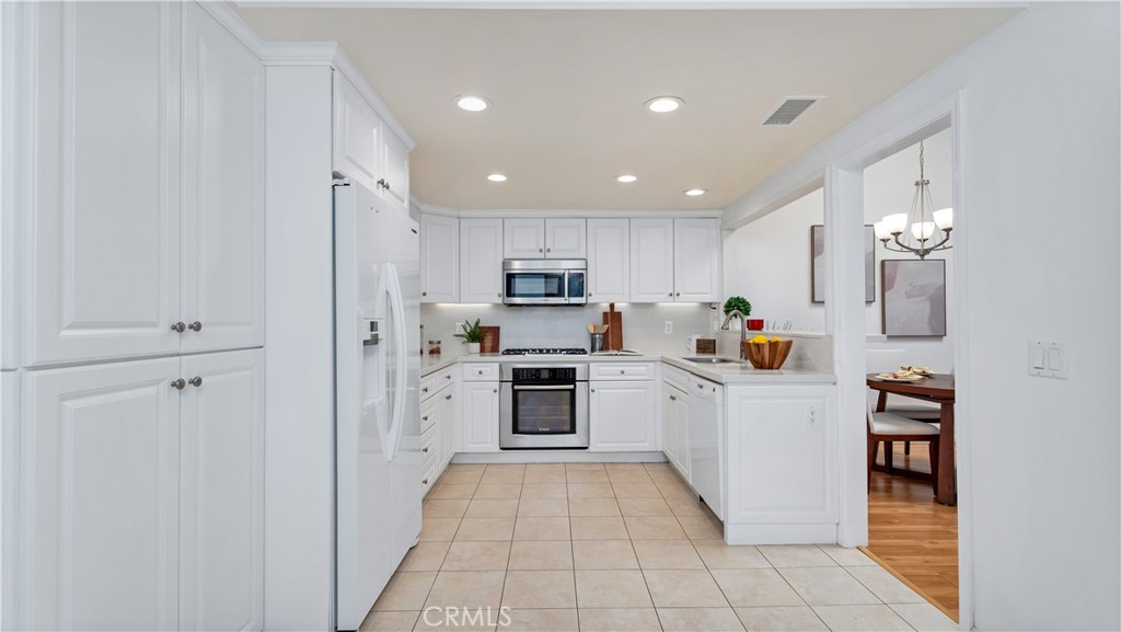 56 Wetstone, Unit 35 Irvine, CA 92604 - Photo 25 of 36 a kitchen with cabinets and stainless steel appliances