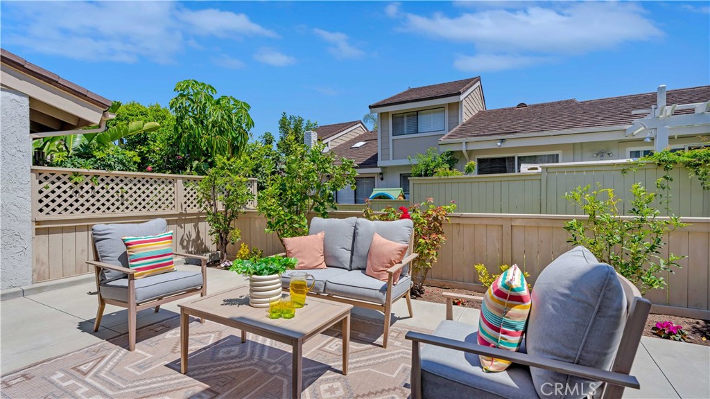 56 Wetstone, Unit 35 Irvine, CA 92604 - Photo 31 of 36 a backyard of a house with table and chairs