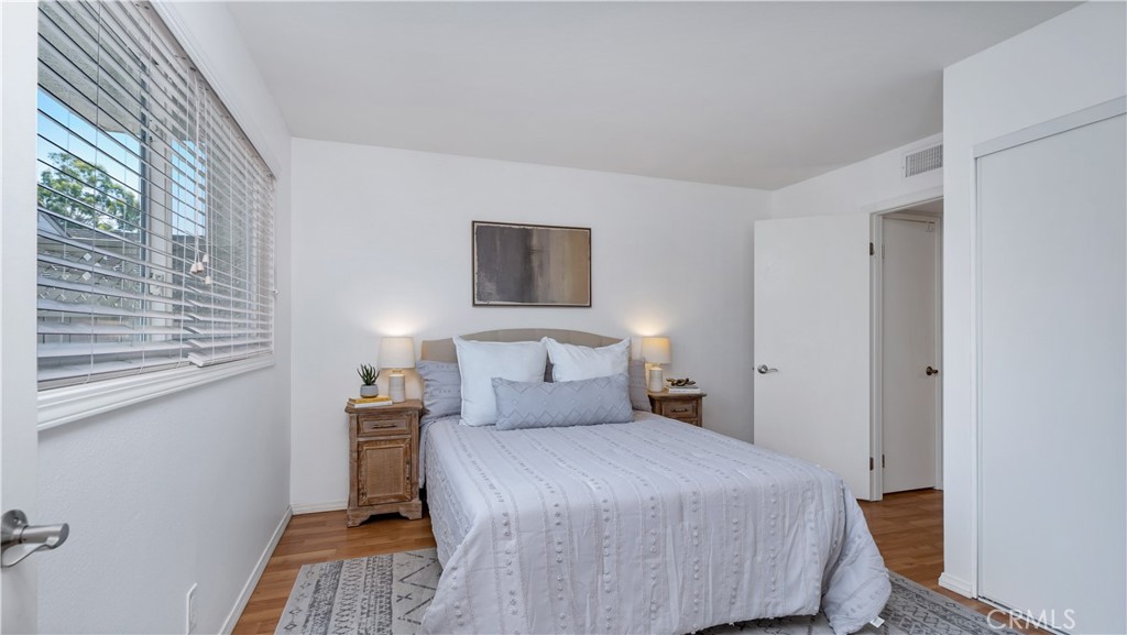 56 Wetstone, Unit 35 Irvine, CA 92604 - Photo 4 of 36 a bedroom with a bed and wooden floor