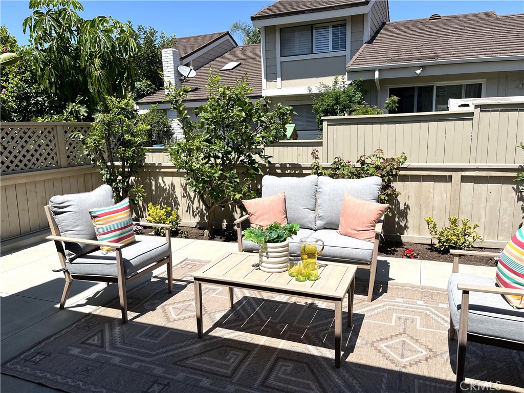 56 Wetstone, Unit 35 Irvine, CA 92604 - Photo 5 of 36 a view of a patio with table and chairs and potted plants