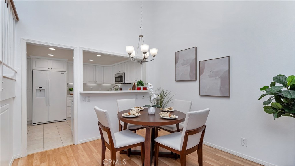 56 Wetstone, Unit 35 Irvine, CA 92604 - Photo 9 of 36 a dining room with furniture and wooden floor