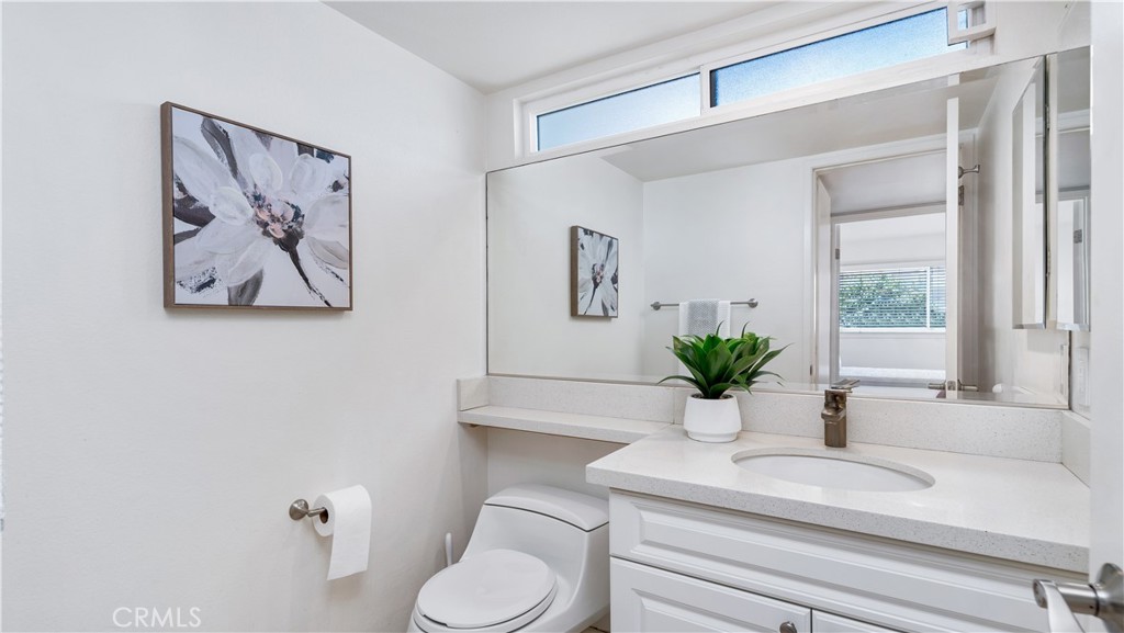 56 Wetstone, Unit 35 Irvine, CA 92604 - Photo 10 of 36 a bathroom with a sink a toilet and a large mirror