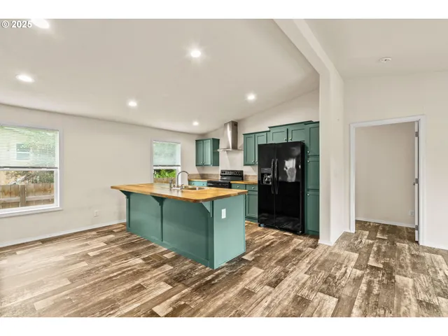 a kitchen with a refrigerator and a sink