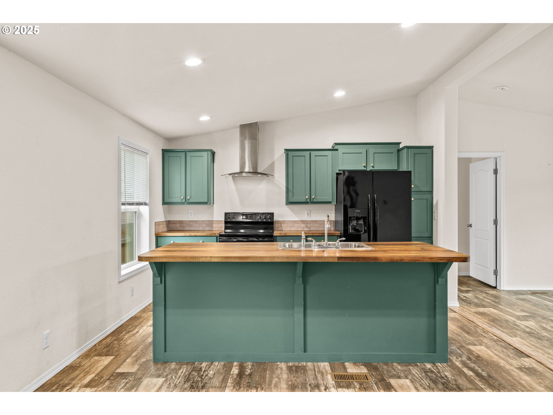 39009 Dexter Road, Unit 32 Dexter, OR 97431 - Photo 6 of 36 a kitchen with kitchen island a stove a refrigerator a sink dishwasher with wooden cabinets and wooden floor