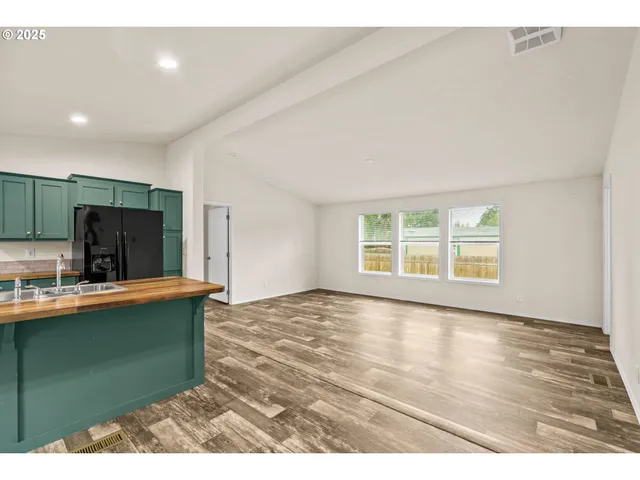 a view of a kitchen with cabinets and wooden floor