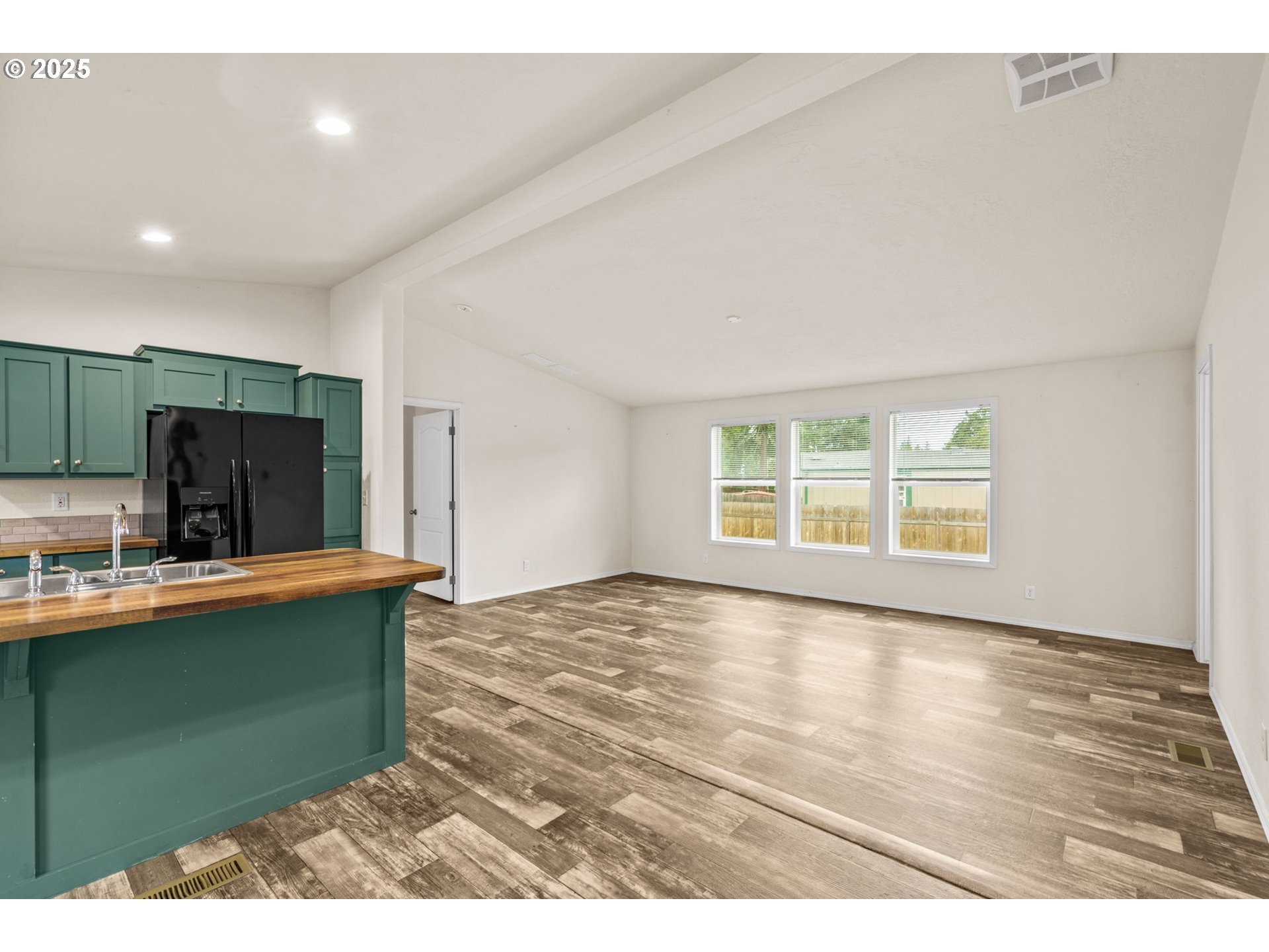 39009 Dexter Road, Unit 32 Dexter, OR 97431 - Photo 7 of 36 a view of a kitchen with cabinets and wooden floor