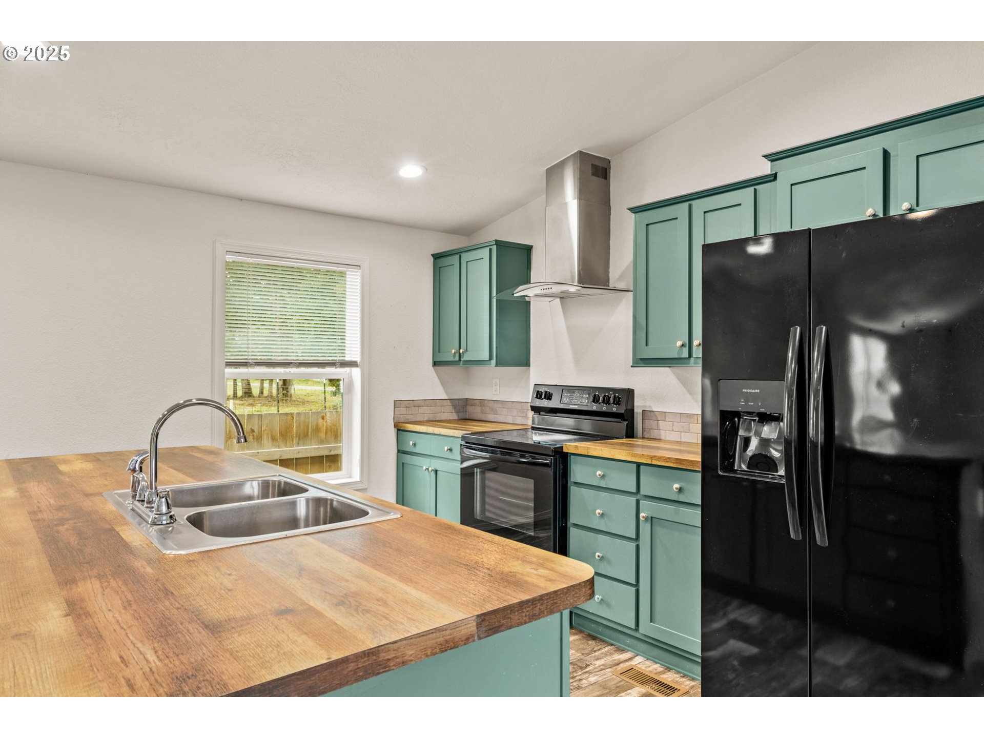 39009 Dexter Road, Unit 32 Dexter, OR 97431 - Photo 9 of 36 a kitchen with stainless steel appliances kitchen island granite countertop a refrigerator and a stove top oven