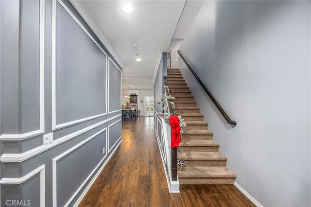 a dining room with furniture a chandelier and wooden floor